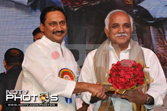 Producer Sudhakar Babu accepts award and a bouquet of roses from the Chief Minister.