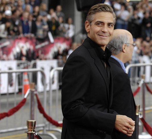 George Clooney, a cast member in Ocean's Thirteen, looks back for photographers at the premiere of the film at Grauman's Chinese Theatre in Los Angeles.