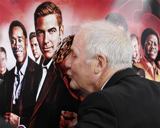 Jerry Weintraub, producer of the film Ocean's Thirteen, kisses the poster at the premiere of the film at Grauman's Chinese Theatre in Los Angeles.