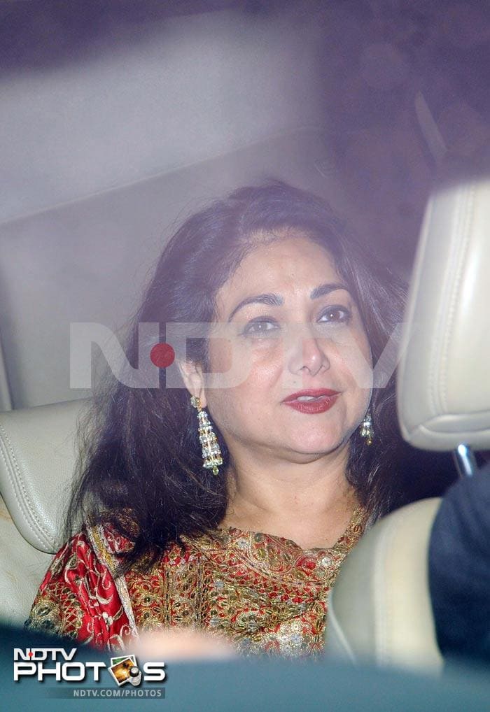 Tina Ambani in a red zari embellished outfit.