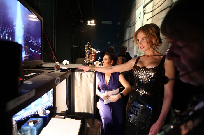 Backstage at the Oscars, Nicole Kidman keeps an eye on proceedings.