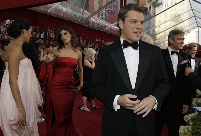 Actors Matt Damon, center, George Clooney, second from right, and Jeff Bridges, right, are interviewed as they arrive at the 82nd Academy Awards on Sunday, March 7, 2010, in the Hollywood section of Los Angeles. Elisabetta Canalis, second from left, girlfriend of Clooney, talks with Luciana Boz�n Barroso, wife of Damon. (Photo: AP)