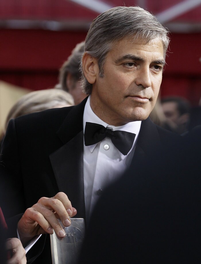 George Clooney holds a flask as he arrives at the 82nd Academy Awards on Sunday, March 7, 2010, in the Hollywood section of Los Angeles. (Photo: AP)