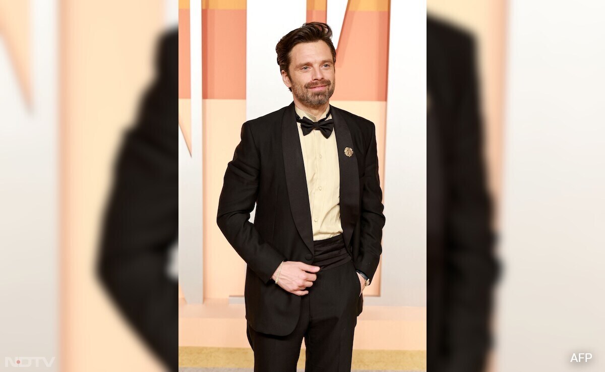 Sebastian Stan looked dapper in a black suit by Prada, with a matching bowtie. (Image Courtesy: AFP)