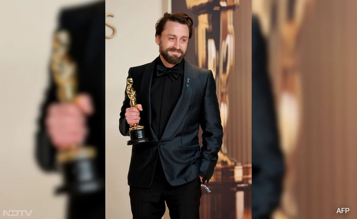 Kieran Culkin looked sharp in a custom Zegna suit, featuring a navy jacket, black button-up bowtie and trousers. (Image Courtesy: AFP)