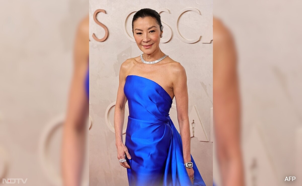 Michelle Yeoh in a custom Balenciaga couture gown and Boucheron jewels, was one of the best looks of the night. (Image Courtesy: AFP)