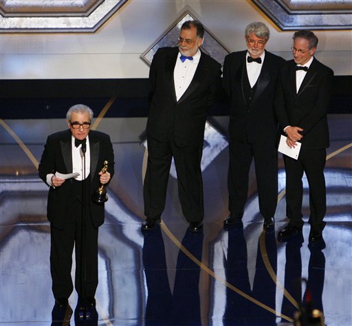 Director Martin Scorsese accepts the Oscar for best director for his work on The Departed as directors from left, Francis Ford Coppola, George Lucas and Steven Spielberg look on at the 79th Academy Awards