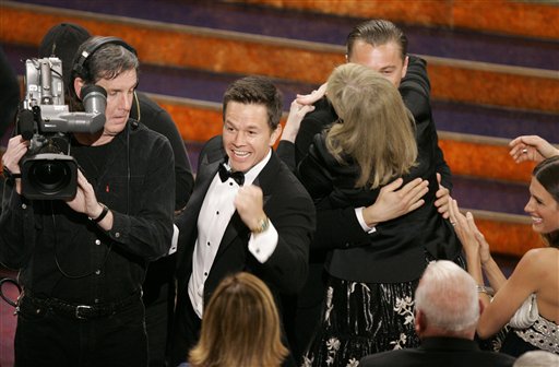 Leonardo DiCaprio, right, celebrates with Mark Wahlberg, left, and cast members after the film The Departed won best motion picture of the year at the 79th Academy Awards