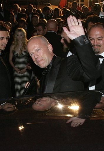 American actor Bruce Willis waves as he enters a car following the screening of the film Over the Hedge, at the 59th International film festival in Cannes, southern France.
