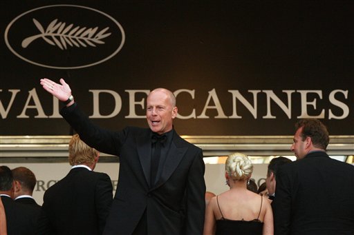 American actor Bruce Willis waves as he arrives for the screening of the film Over the Hedge, at the 59th International film festival in Cannes.