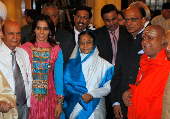 Indian President Pratibha Patil, center, poses for photographs with some of the receipients of the Padma awards, India's highest civilian awards at the Presidential Palace in New Delhi, India, Wednesday, March 31, 2010. (AP Photo/Mustafa Quraishi)