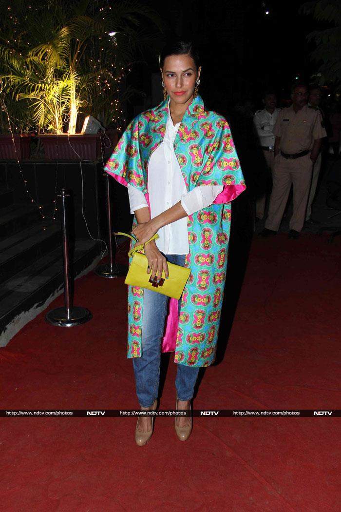 Neha Dhupia wore a printed green overcoat over a white shirt and blue denims.