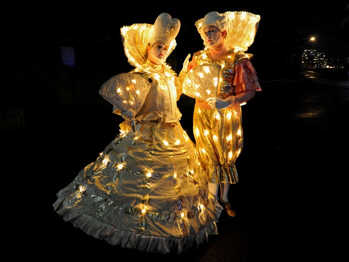 Two performers entertain visitors to the Vivid Sydney festival of light, music and ideas in Sydney on May 27, 2010. "Macquarie Visions", is being held along Sydney's iconic Macquarie Street as part of Vivid Sydney, the largest light and music festival in the Southern Hemisphere and will see city buildings illuminated by breathtaking projections and moving light images. (Photo: AFP)