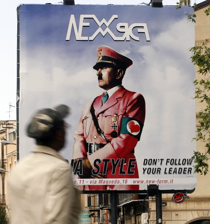 Adolf Hitler in a pink uniform is seen on a billboard in a street of the Sicilian city of Palermo for a fashion advertisement on May 24, 2010. The advertisment, shows the German dictator wearing an armband with a red heart instead of a swastika and a slogan that says "Change Your Style. Don't Follow Your Leader". (Photo: AFP)