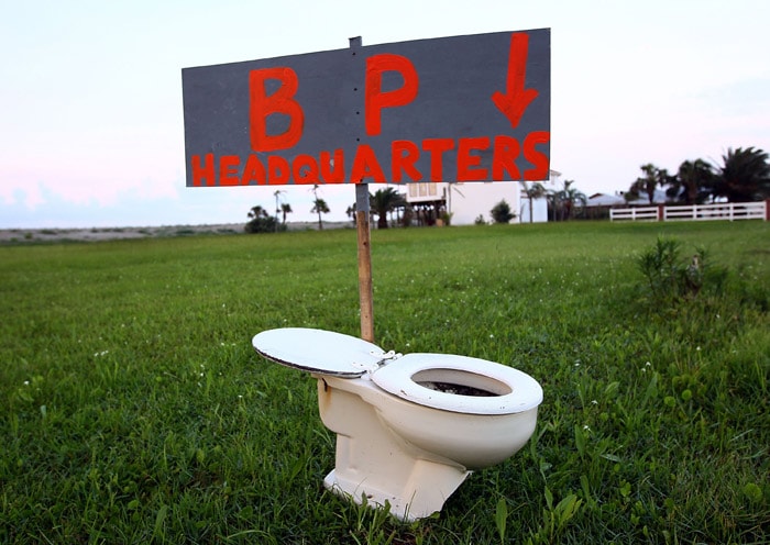 A sign left by the side of the road points to a toilet on May 30, 2010 near Grand Isle, Louisiana. With BP's failure to stop the flow of oil from the Deepwater Horizon well, residents of the Gulf Coast are growing increasingly frustrated. (Photo: AFP)