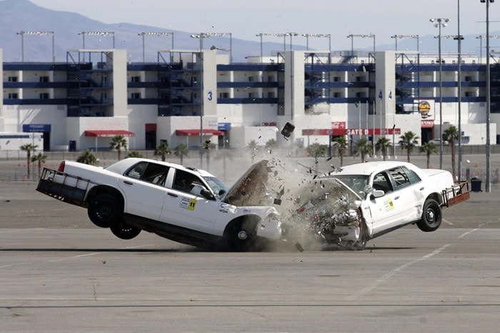 Two retired police cruisers have a head on collision during live, full scale motor vehicle crash testing during the ARC-CSI Crash Conference at the Las Vegas Motor Speedway on Monday, May 24, 2010. About 300 traffic officers and collision reconstruction experts are attending the annual three day conference. The two cars in the photo were driven by remote control. (Photo: AP)