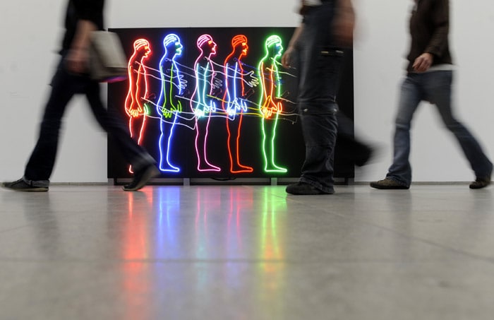 Visitors of the exhibition 'Bruce Nauman. Dream Passage' are passing Nauman's piece of art 'Five Marching Men' (1985) in the museum Hamburger Bahnhof in Berlin, Germany, on Thursday, May 27 2010. The exhibition will be shown until October, 10. 2010. (Photo: AP)