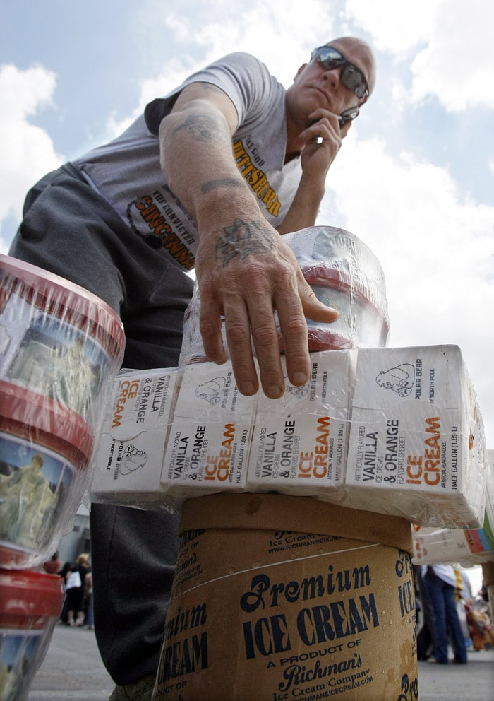 Louie Sanders talks on his phone while picking up a stack of free ice cream that was being given away at the site of the former Reinhold Ice Cream factory in Pittsburgh, on Tuesday, May 25, 2010. About 10,000 gallons of ice cream were being given away at the factory that is being converted into an oil processing facility. (Photo: AP)