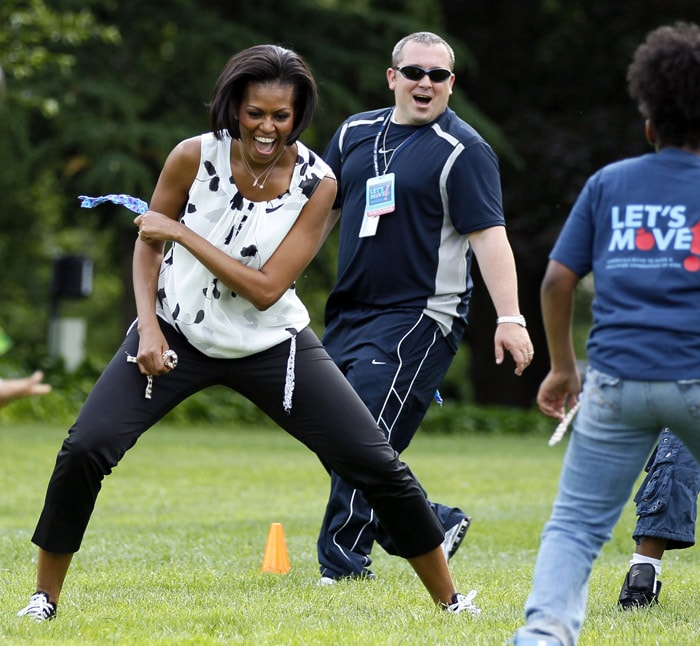 US First Lady Michelle Obama plays with kids at an event on the South Lawn of the White House, on Tuesday, May 25, 2010, in Washington, to kick-off the South Lawn Series. The South Lawn Series are summer activities happening at the White House to promote physical activity and engage children from the DC community in support of Let's Move! (Photo: AP)