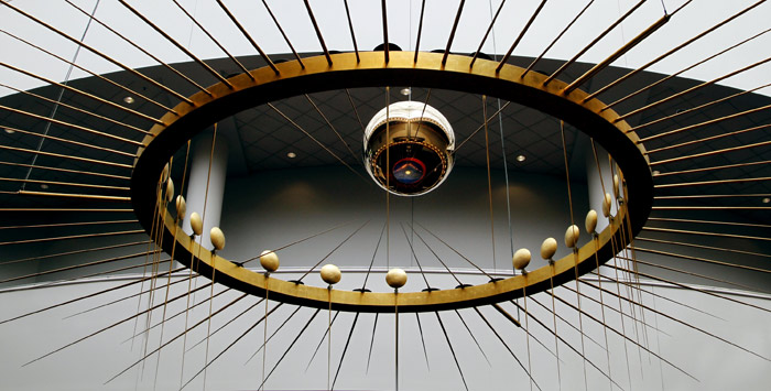 The giant ball of the world's largest Foucault Pendulum tells time as it swings suspended below a glass spire at the Oregon Convention Center in Portland, Oregon, on Wednesday, May 26, 2010. The direction along which the pendulum swings rotates with time because of Earth's daily rotation. (Photo: AP)