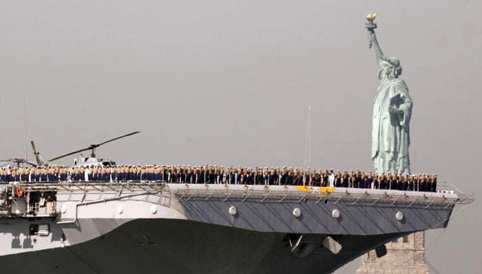 Marines and sailors line the deck of the US Navy amphibious assault ship USS Iwo Jima as it passes the Statue of Liberty in New York on Wednesday, May 26, 2010. The Iwo Jima and other military vessels are visiting New York as part of Fleet Week. (Photo: AP)