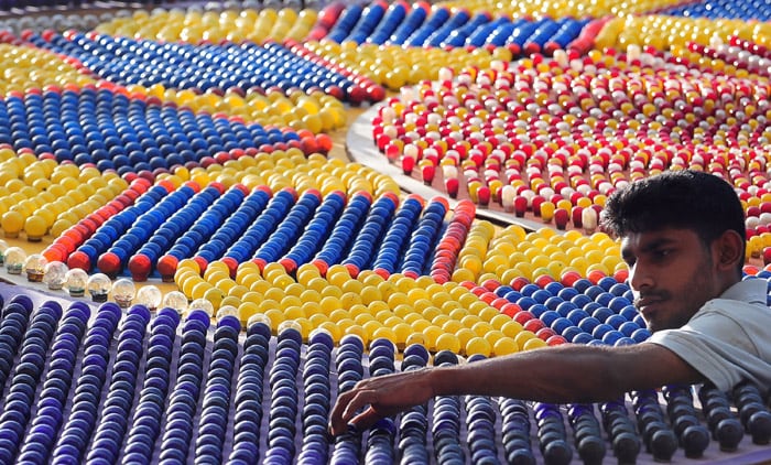 A Sri Lankan worker adjusts lightbulbs on a pandal, a coloured structure that is illuminated with bulbs, in Colombo on May 25, 2010, ahead of the key Buddhist festival of Wesak. Buddhists commemorates the birth of Buddha, his attaining enlightenment and his passing away on the full moon day of May which falls on May 27 this year. (Photo: AFP)