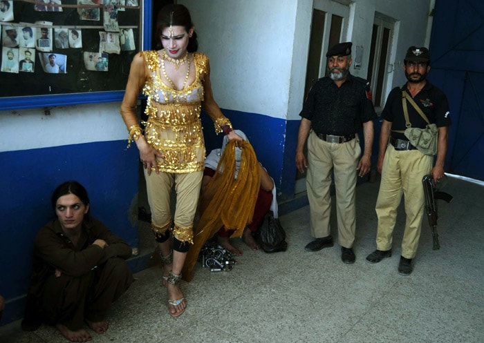 Pakistani eunuch Kashif (L) sits in police station in Peshawar on May 25, 2010. Police arrested Malik Iqbal, a man for marrying Kashif also known as Rani in northwestern Pakistan. Under Pakistani law, gay marriage or a man's marriage to a eunuch is a criminal offence and carries a maximum 10-year prison sentence. (Photo: AFP)