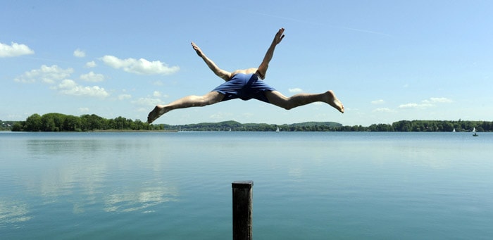 A young man jumps into the Woerthsee lake near Inning am Ammersee, southern Germany, on May 24, 2010. Temperatures reached 20 degrees Celsius and even more in the southern state of Bavaria. (Photo: AFP)