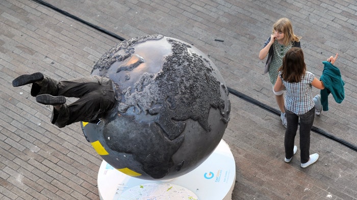 Children discover a giant model globe, part of an art installation entitled 'Cool Globes' against global warming and climate change, in Marseille, southern France, on June 3, 2010. Ahead of the 6th edition of the World Water Forum which will be held in Marseille in 2012, 68 originals globes - designed by artists around environmental theme - will be displayed in the streets of Marseille from June 8 to October 8, 2010. Cool Globes premiered in Chicago and went on tour across the world from Washington to Copenhagen. (Photo: AFP)