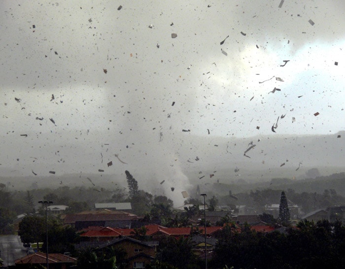 Debris flies through the air as a freak tornado tears through the coastal town of Lennox Head on June 3, 2010. The storm levelled 12 homes and damaged another 30, with twisting winds carving out a 300 metre-wide path of destruction, injuring six people and leaving thousands without power. (Photo: AFP)