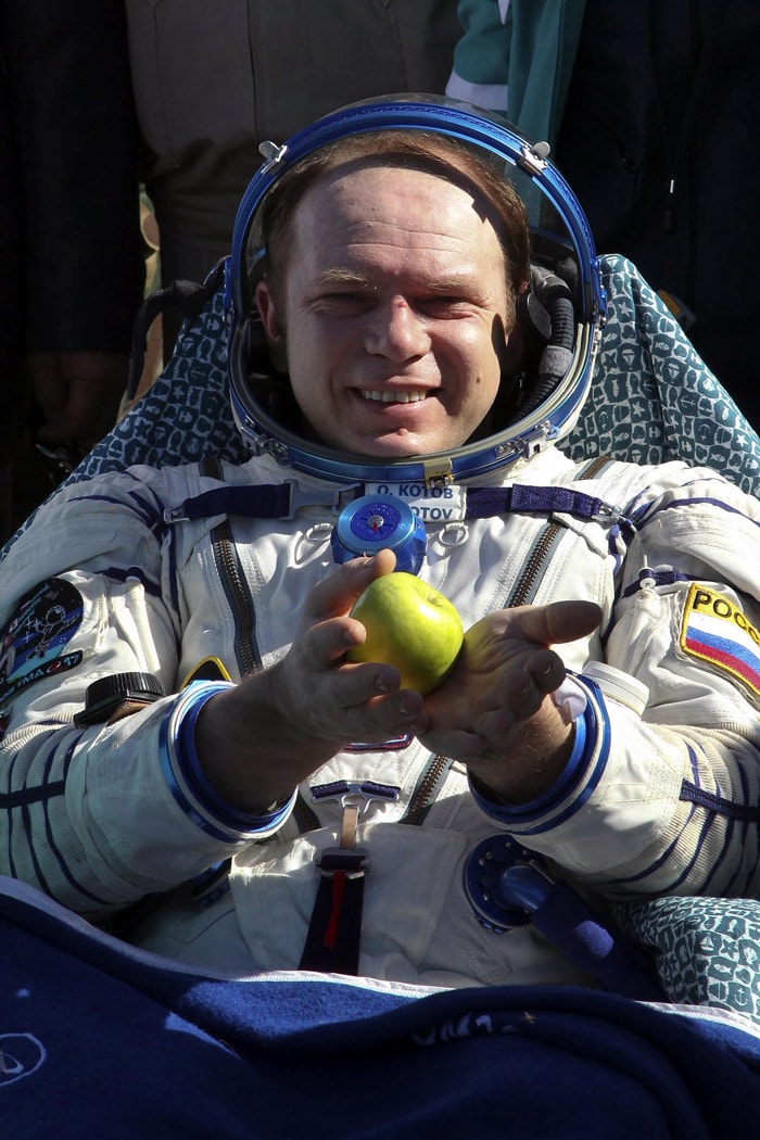 Commander Oleg Kotov of Russia holds an apple minutes after the landing near the town of Zhezkazgan June 2, 2010. Kotov, Japan Aerospace Exploration Agency astronaut Soichi Noguchi and US astronaut Timothy Creamer who make up Russian Expedition 23 and are commanded by Kotov, left Earth in December of last year for the $100 billion, 16-nation International Space Station (ISS). (Photo: AFP)