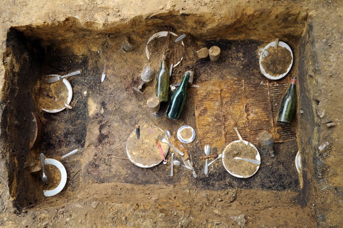 Picture taken on June 2, 2010 at Jouy-en-Josas, of the remains of an open-air banquet shoveled underground almost 30 years ago by Switzerland's artist Daniel Spoerri as an art performance. Supervised by the creme-de-la-creme of French archeology, a bunch of dusty diggers are unearthing the leftovers from a work now known as "The lunch under the grass" -- a meal for 80 in sumptous gardens south of Paris where the star course was offal. (Photo: AFP)