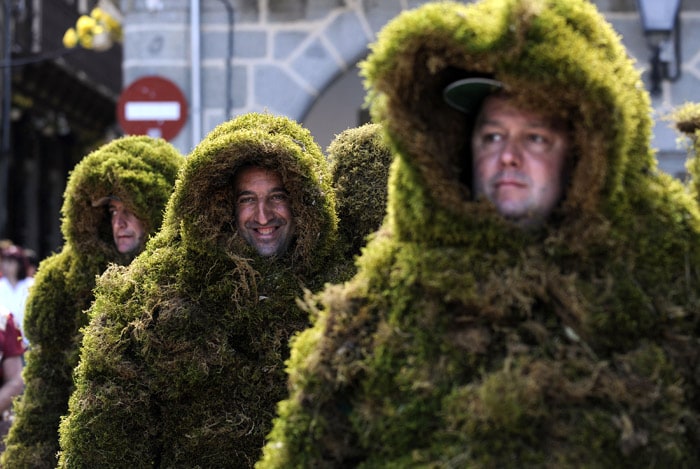 Three 'Hombres de Musgo' (Moss Men) take part in the Corpus Christi procession on June 6, 2010, in the Spanish village of Bejar, Salamanca province. The Moss Men have been taking part in the Corpus Christi procession since 1397. (Photo: AFP)