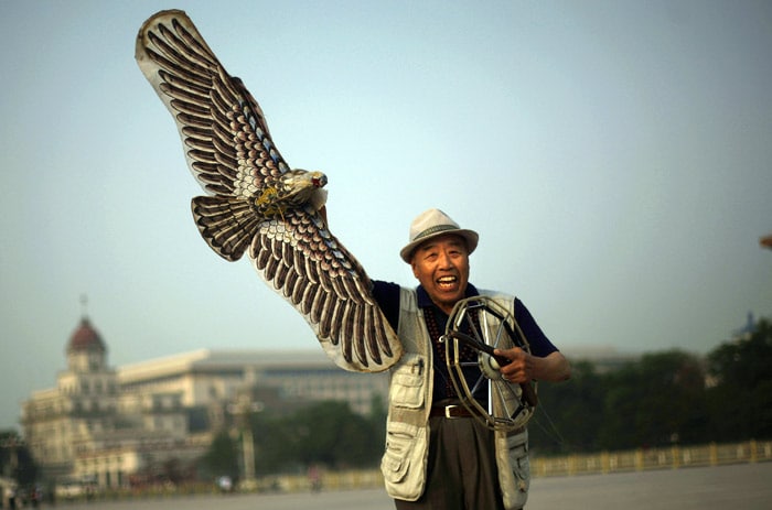 An elderly Chinese man, laughs while preparing to launch his eagle shaped kite in Tiananmen Square in Beijing, China, on Friday, June 4, 2010. Chinese authorities, tightend security on Tiananmen square during the anniversary of the deadly 1989 crackdown on pro-democracy protestors, which is marked for Friday. (Photo: AP)