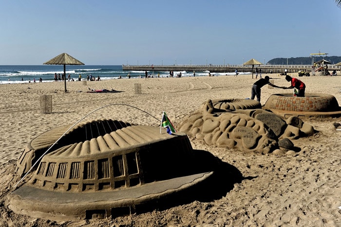 Street artists make sand sculptures of the soccer stadium to be used in the South Africa 2010 World Cup at the beach of Durban, on June 5, 2010. (Photo: AFP)