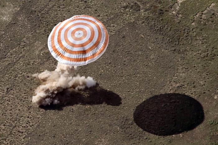 The Soyuz capsule lands near the town of Zhezkazgan on June 2, 2010. US astronaut Timothy Creamer, Commander Oleg Kotov of Russia and Japan Aerospace Exploration Agency astronaut Soichi Noguchi who make up Russian Expedition 23 and are commanded by Kotov, left Earth in December of last year for the $100 billion, 16-nation International Space Station (ISS). (Photo: AFP)