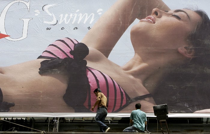 Workers work on a giant billboard advertising swimwear on a highway in the town of Dbayeh, north of Beirut on June 2, 2010. (Photo: AFP)