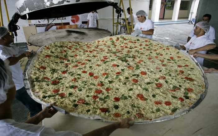 Pizza chefs move an oversized pizza into an oven in Sao Paulo, on Saturday July 10, 2010. Sao Paulo's Tourism Office celebrated World Pizza Day on Saturday. (Photo: AP)