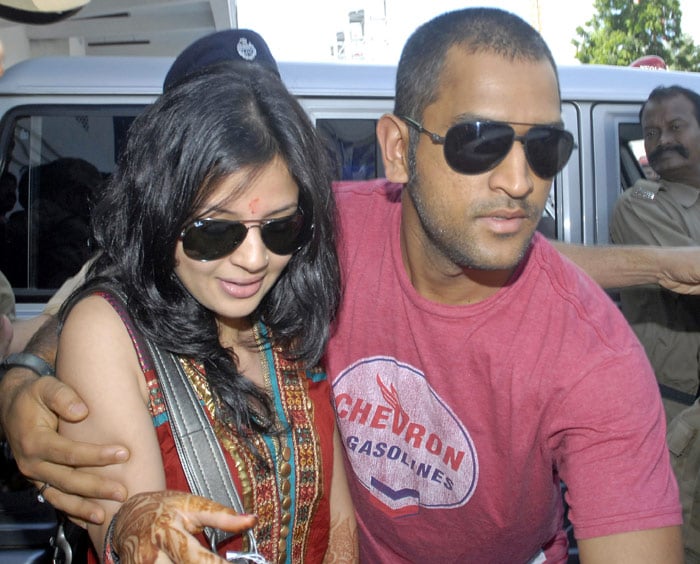 Indian cricket captain Mahendra Singh Dhoni and his wife Sakshi arrive at the airport in Kolkata on July 8, 2010. Dhoni and Sakshi married in a hush-hush ceremony on July 4 at a farmhouse near Dehradun. (Photo: AFP)