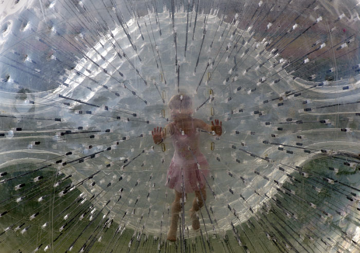 A girl walks in a Walking Ball at an entertainment center in the town of Logoisk, 40 km north of Minsk, Belarus, on Saturday, July 10, 2010. (Photo: AP)