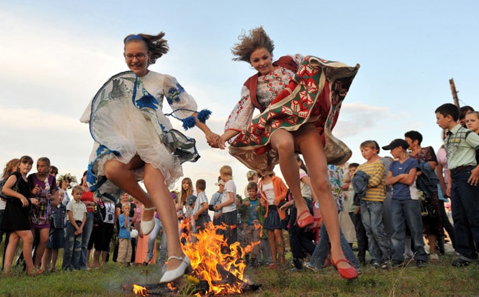 Belarussian girls wearing tradionnal dresses jump while celebrating Ivan Kupala Night, a traditional Slavic holiday, 270km south of Minsk in Turov on July 6, 2010. During the celebration, originating in pagan times, people plait wreaths, jump over fires, and swim. (Photo: AFP)