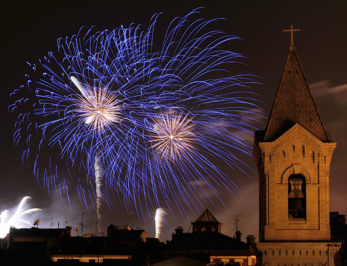 Fireworks explode over Pamplona, north of Spain, during the San Fermin Festival, on July 8, 2010. The festival is a symbol of Spanish culture, despite heavy condemnation from animal rights groups, and attracts thousands of tourists to watch the bull runs. (Photo: AFP)