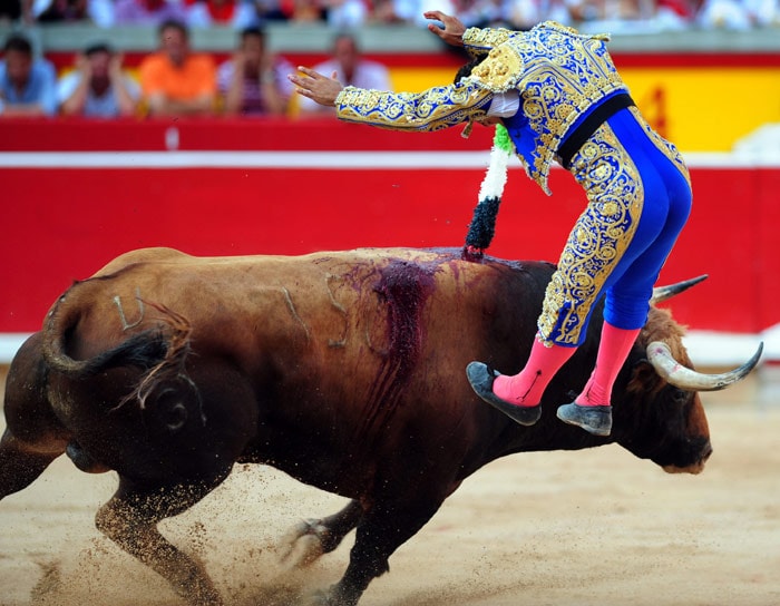 Spanish matador Antonio Ferrera jumps as a bull charges past during a bullfight at the San Fermin festival in Pamplona, northern Spain, on July 9, 2010. (Photo: AFP)