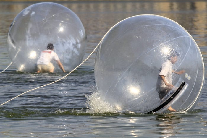 Participants walk in their 'Walk Water Balls' on Lake Alster in Hamburg, Germany on Saturday July 10, 2010. (Photo: AP)