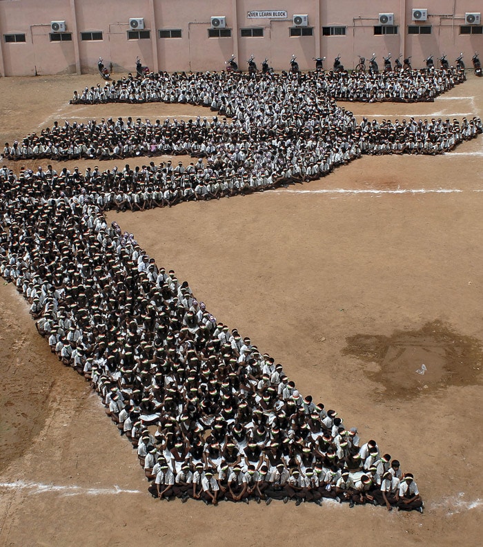 School students make a formation depicting the new symbol of the Indian Rupee in Chennai, on Friday, July 16, 2010. India got a new symbol for its currency, the rupee, which the government hopes will reflect the growing might of the Indian economy. The new symbol, chosen after a nationwide competition, shows a combination of the Roman letter R and its Hindi equivalent. (Photo: AP)