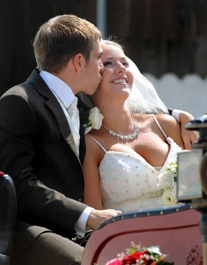 Germany's defender Philipp Lahm kisses his wife Claudia, former Claudia Schattenberg, in a carriage after their marriage in the church of Kleinhelfendorf, southern Germany, on July 14, 2010. Lahm came back from the FIFA world Cup in South Africa on July 12, where his team placed third. (Photo: AFP)