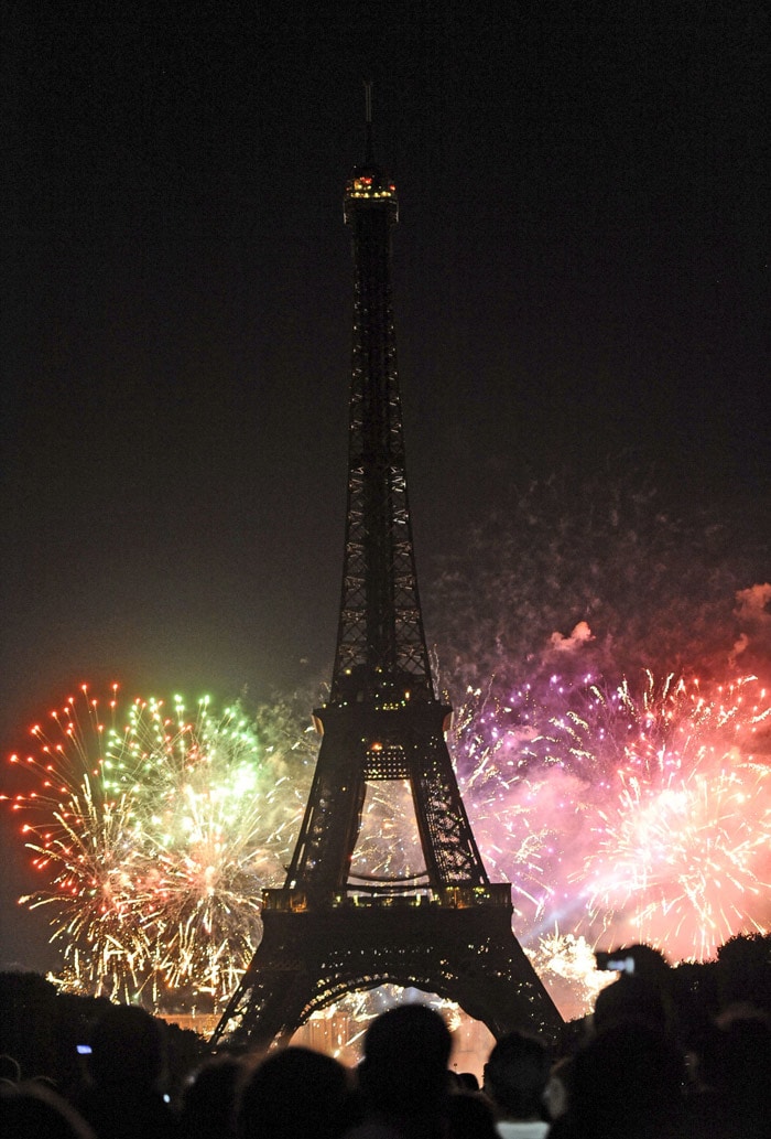 Fireworks burst over the Eiffel Tower during traditional Bastille Day celebrations on July 14, 2010 in Paris. A military parade and fireworks are held each year to commemorate the storming of the Bastille fortress in Paris by revolutionaries in 1789, the symbolic starting point of the movement that led to the first French republic. (Photo: AFP)