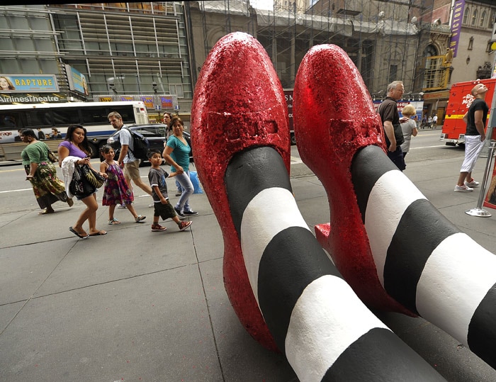 A pair of 6-foot-tall ruby red slippers are unveiled outside Madame Tussauds New York on 42nd Street in Times Square on July 13, 2010 to celebrate the launch of <i>The Wizard of Oz Cinema 4D Experience</i> and the interactive <i>Land of Oz</i> exhibit at Madame Tussauds New York. (Photo: AFP)