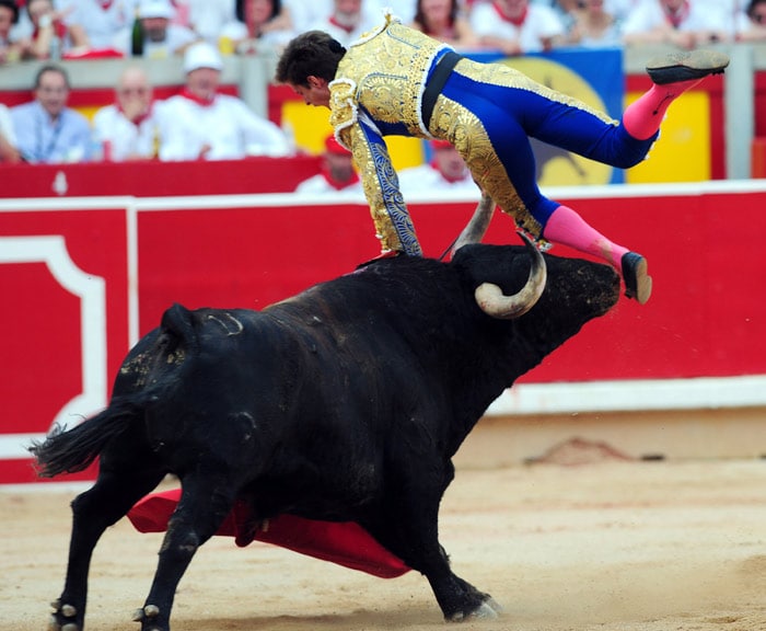 Spanish matador el Juli is injured by a bull during a bullfight of the San Fermin festival at Pamplona's bullring in northern Spain, on July 12, 2010. (Photo: AFP)