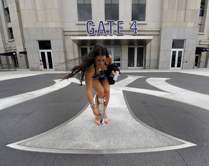 A fan places flowers down outside of Yankee Stadium in New York July 13, 2010 after hearing the news of the death of New York Yankees owner George Steinbrenner.  Steinbrenner, age 80, suffered a heart attack at his home in Tampa. (Photo: AFP)